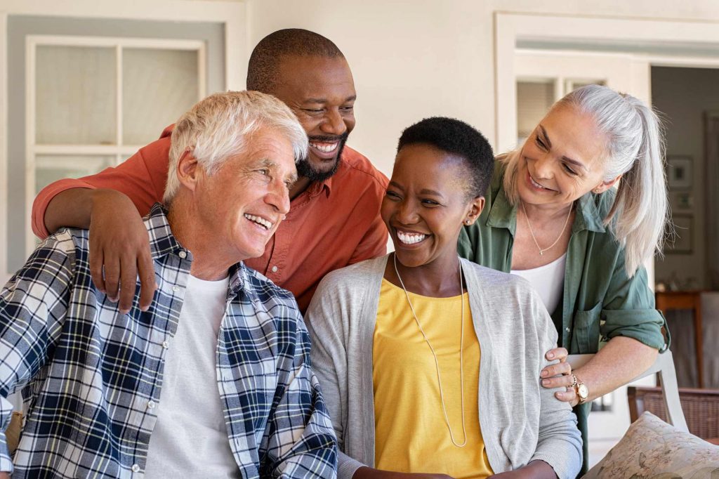 Two middle age couples enjoying a laugh.