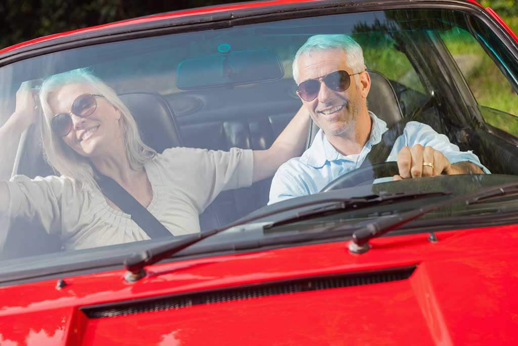 Mature couple enjoying a drive. 